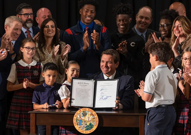 Florida Governor Ron DeSantis signs historic bill expanding school vouchers statewide during a momentous ceremony in Miami on March 27, 2023.